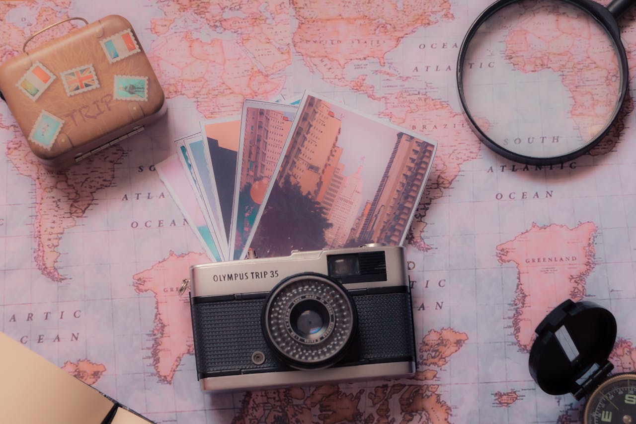 Explore vintage photography with a classic camera and travel-themed setup over a world map.